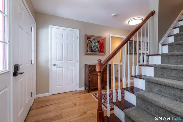 a view of entryway with wooden floor and stairs
