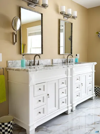 a bathroom with a double vanity sink and a mirror