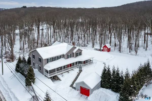 an aerial view of a house with a yard and trees