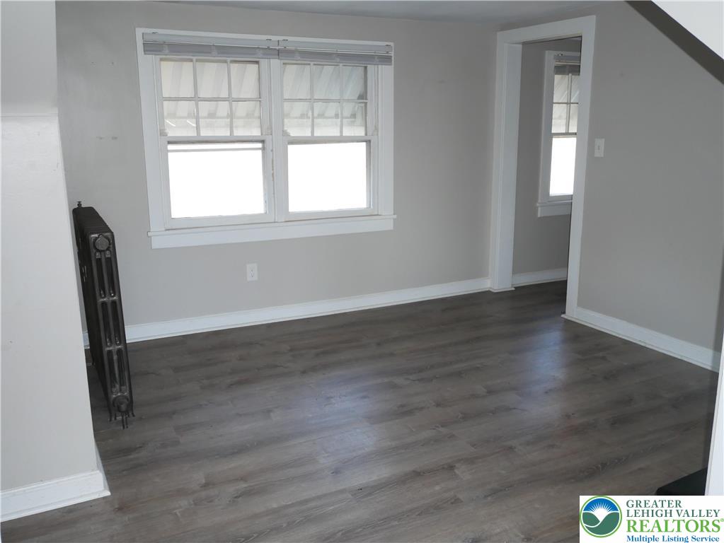 2110 Walnut Street, Unit E Allentown, PA 18104 - Photo 12 of 18 an empty room with wooden floor and windows