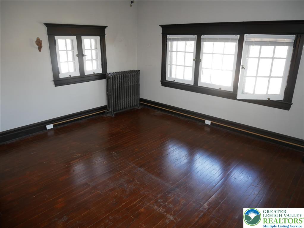 2110 Walnut Street, Unit E Allentown, PA 18104 - Photo 16 of 18 a view of an empty room with wooden floor and a window