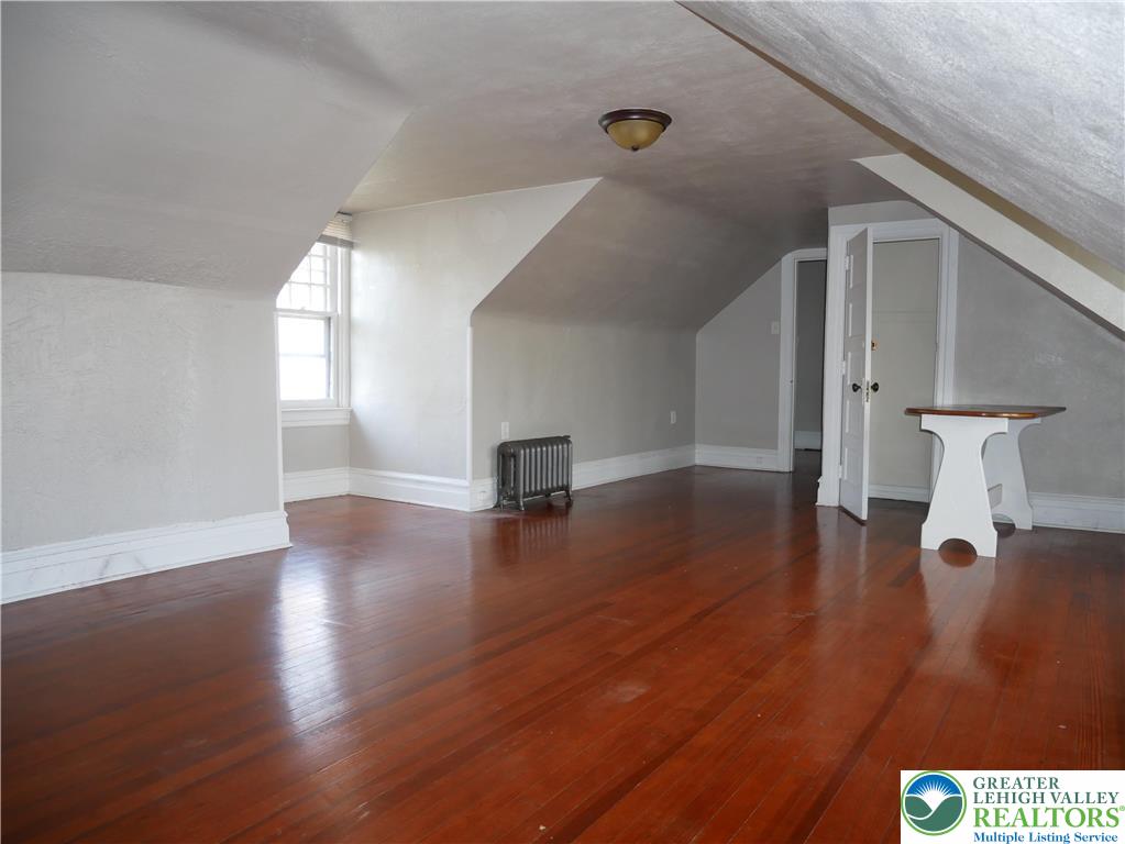 2110 Walnut Street, Unit E Allentown, PA 18104 - Photo 9 of 18 a view of empty room with wooden floor and fan