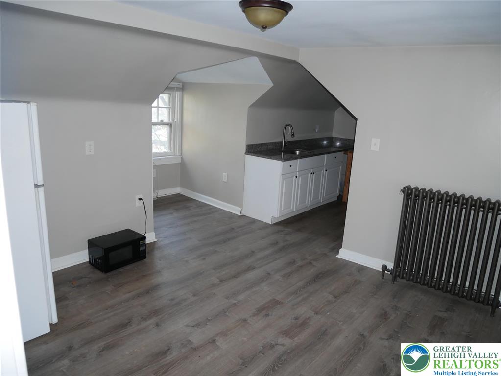 2110 Walnut Street, Unit E Allentown, PA 18104 - Photo 10 of 18 a living room with wooden floor and furniture