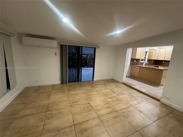 a view of an empty room with a kitchen