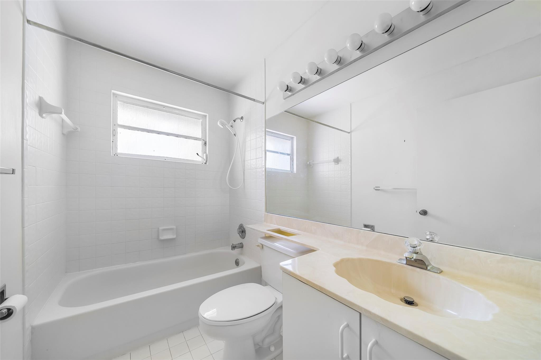 10423 Boca Springs Drive Boca Raton, FL 33428 - Photo 22 of 64 a bathroom with a bathtub shower sink mirror vanity and toilet