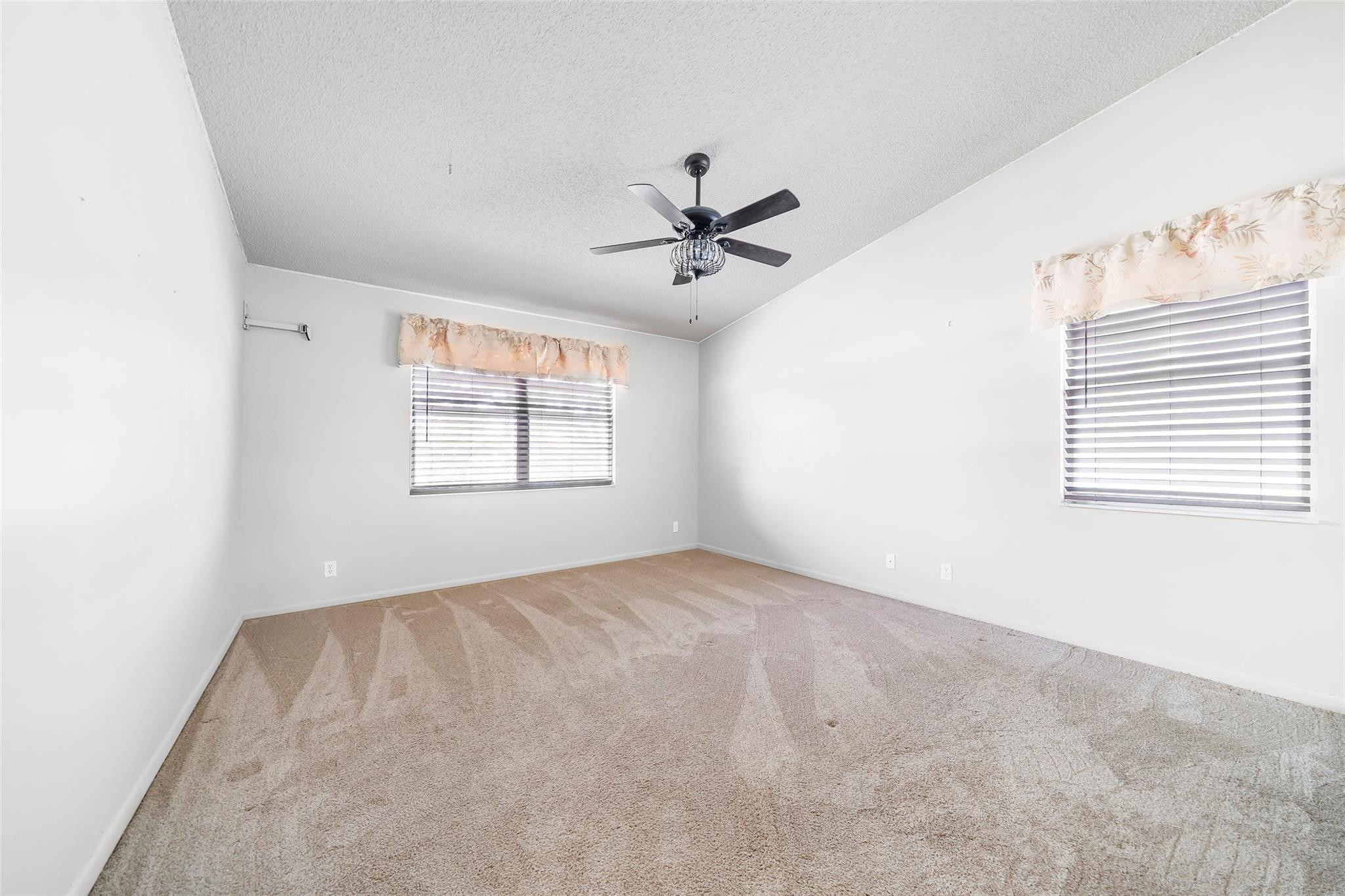 10423 Boca Springs Drive Boca Raton, FL 33428 - Photo 23 of 64 an empty room with windows and ceiling fan