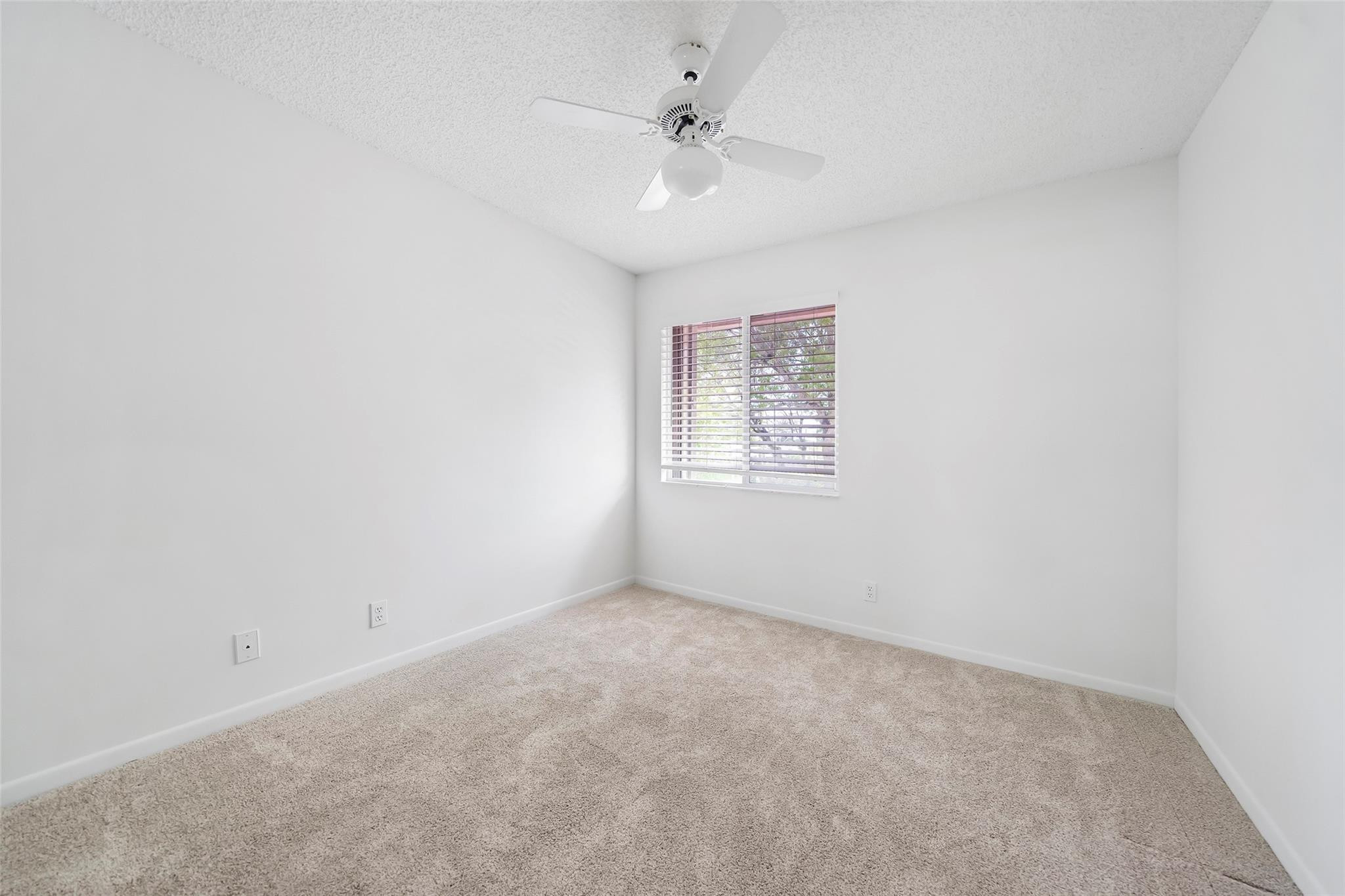 10423 Boca Springs Drive Boca Raton, FL 33428 - Photo 29 of 64 an empty room with windows and ceiling fan