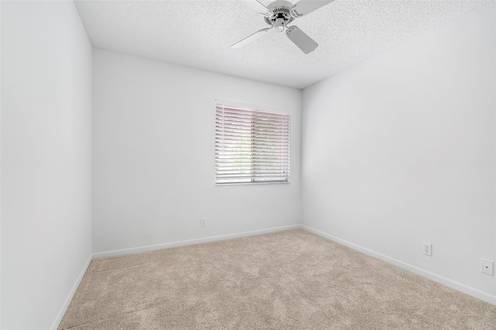 10423 Boca Springs Drive Boca Raton, FL 33428 - Photo 31 of 64 an empty room with a window and a fan