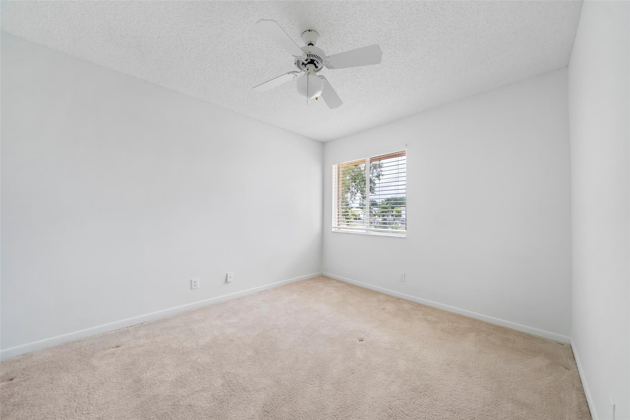 10423 Boca Springs Drive Boca Raton, FL 33428 - Photo 33 of 64 an empty room with a window and a ceiling fan