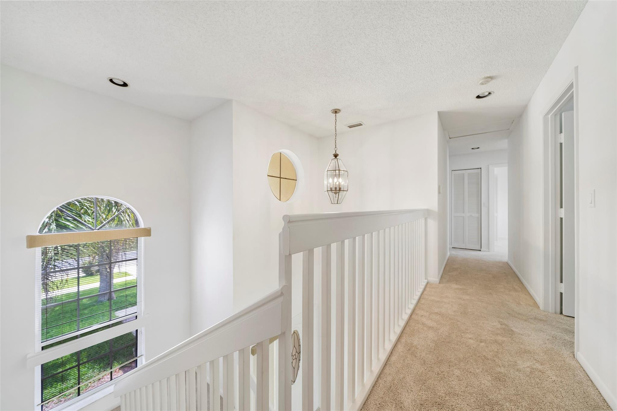 10423 Boca Springs Drive Boca Raton, FL 33428 - Photo 36 of 64 a view of a hallway to a window and a kitchen