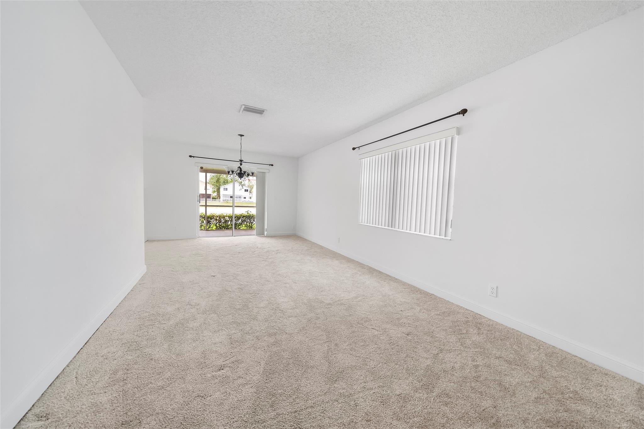 10423 Boca Springs Drive Boca Raton, FL 33428 - Photo 40 of 64 an empty room with windows and cabinet in it