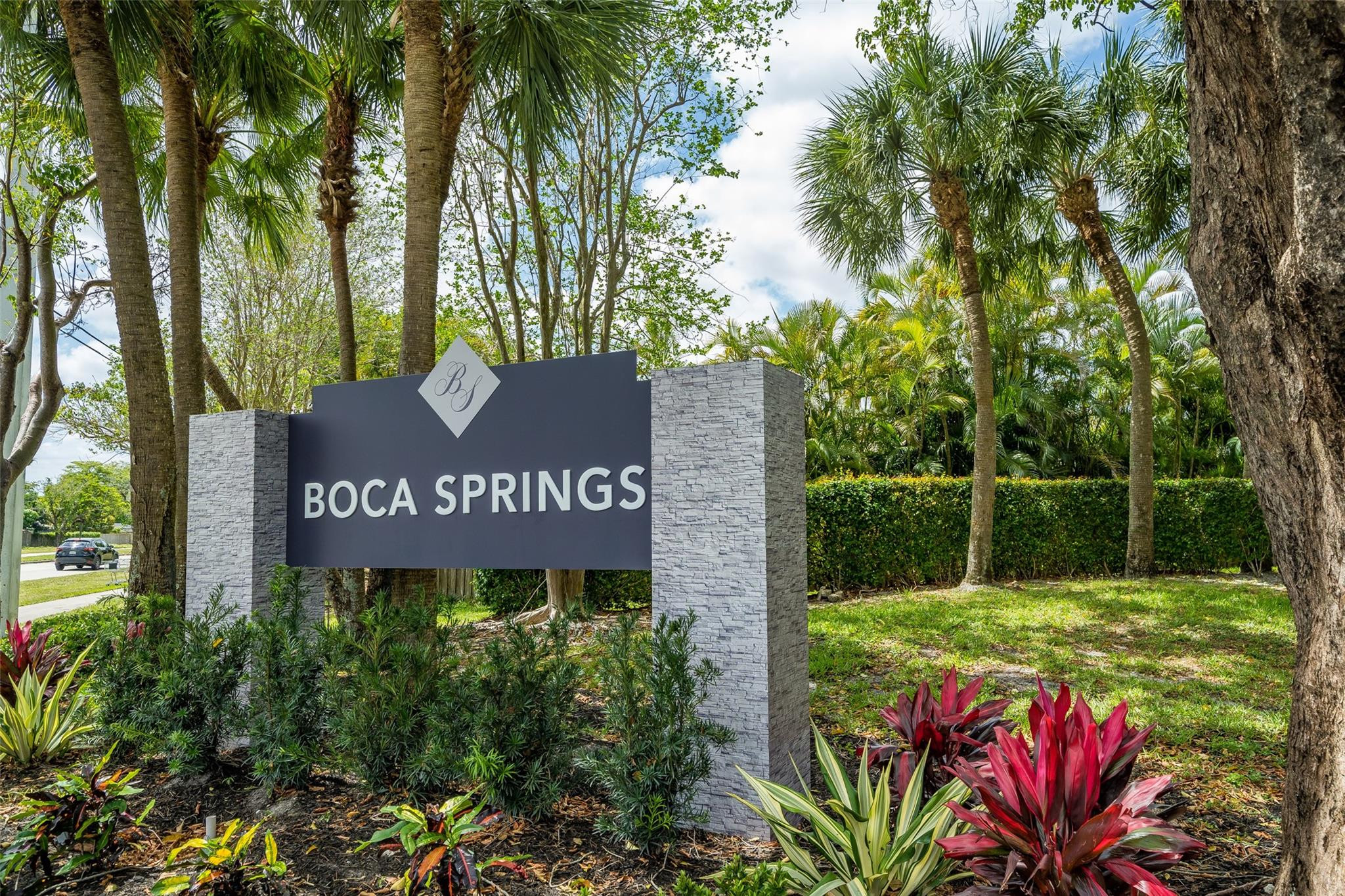 10423 Boca Springs Drive Boca Raton, FL 33428 - Photo 4 of 64 a sign that is sitting on a brick wall