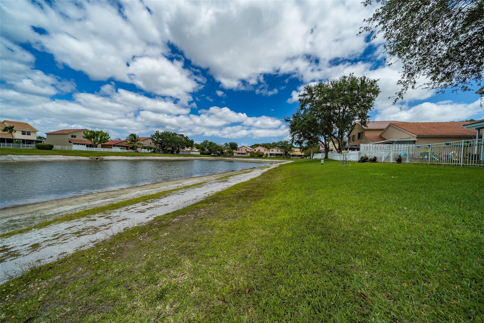 10423 Boca Springs Drive Boca Raton, FL 33428 - Photo 46 of 64 a view of a lake with houses in the back