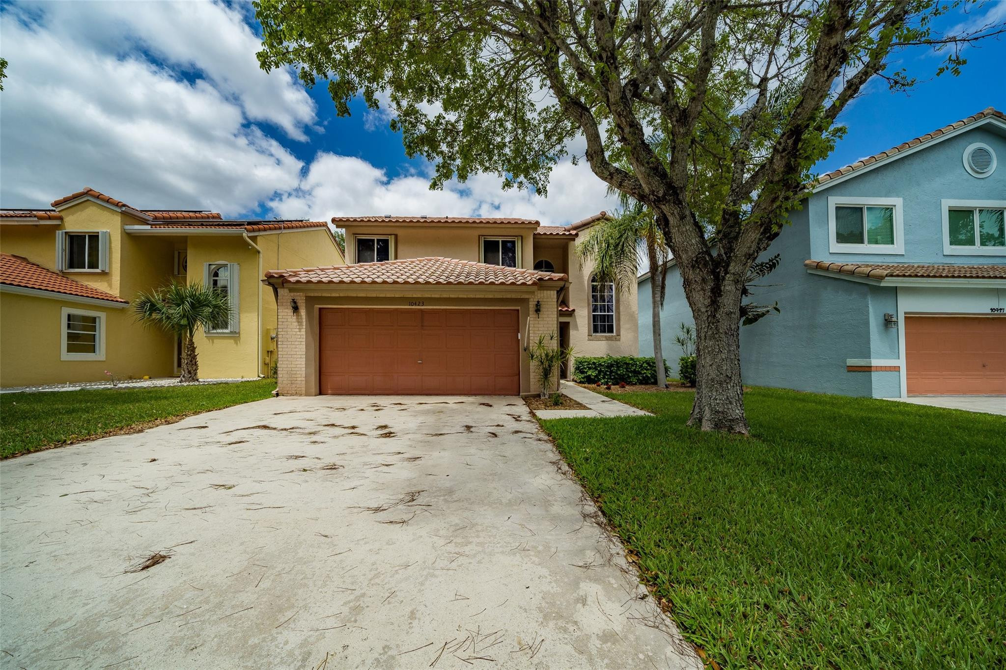 10423 Boca Springs Drive Boca Raton, FL 33428 - Photo 49 of 64 a front view of a house with a yard and garage