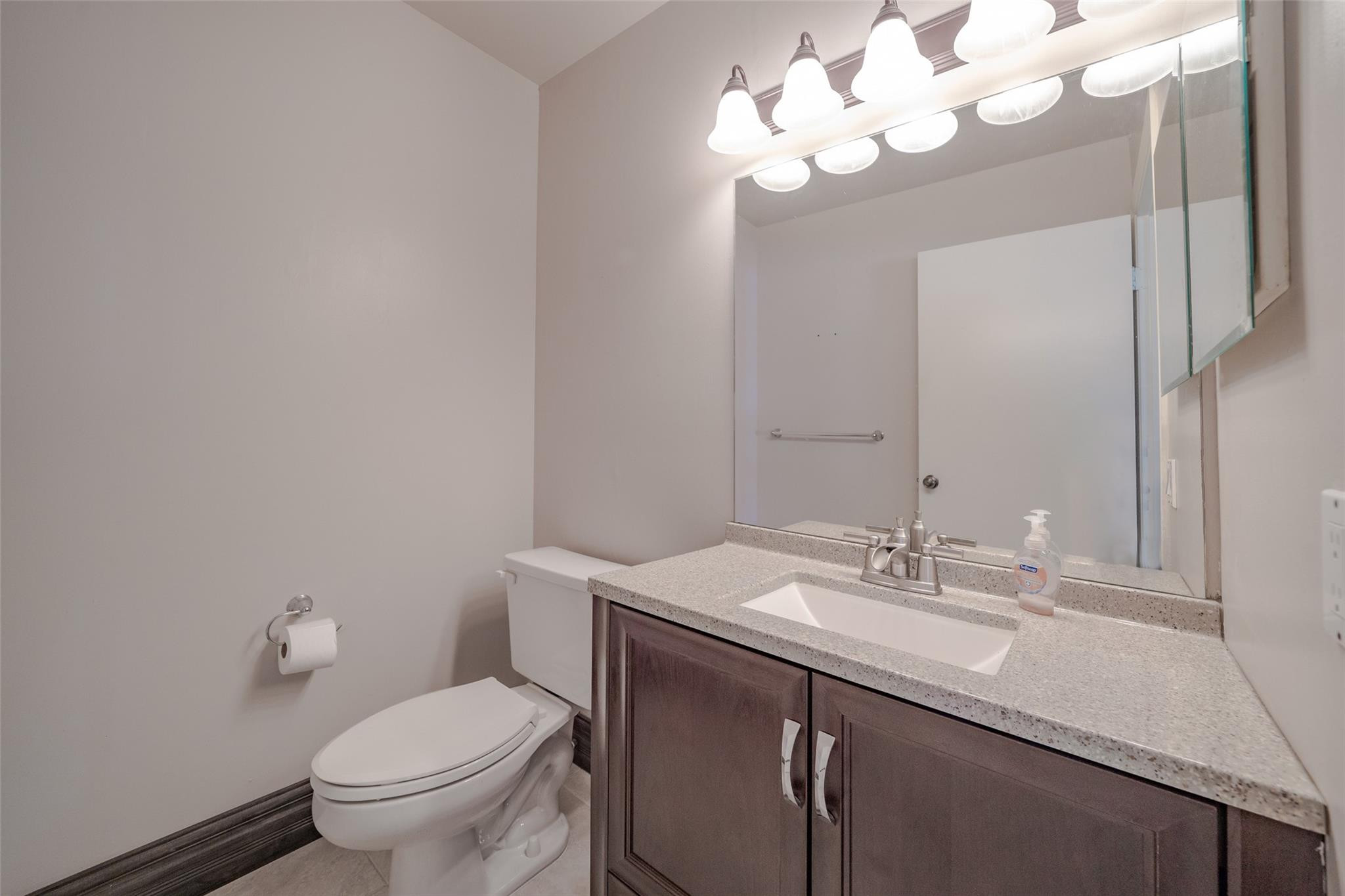 10423 Boca Springs Drive Boca Raton, FL 33428 - Photo 50 of 64 a bathroom with a sink vanity mirror and toilet