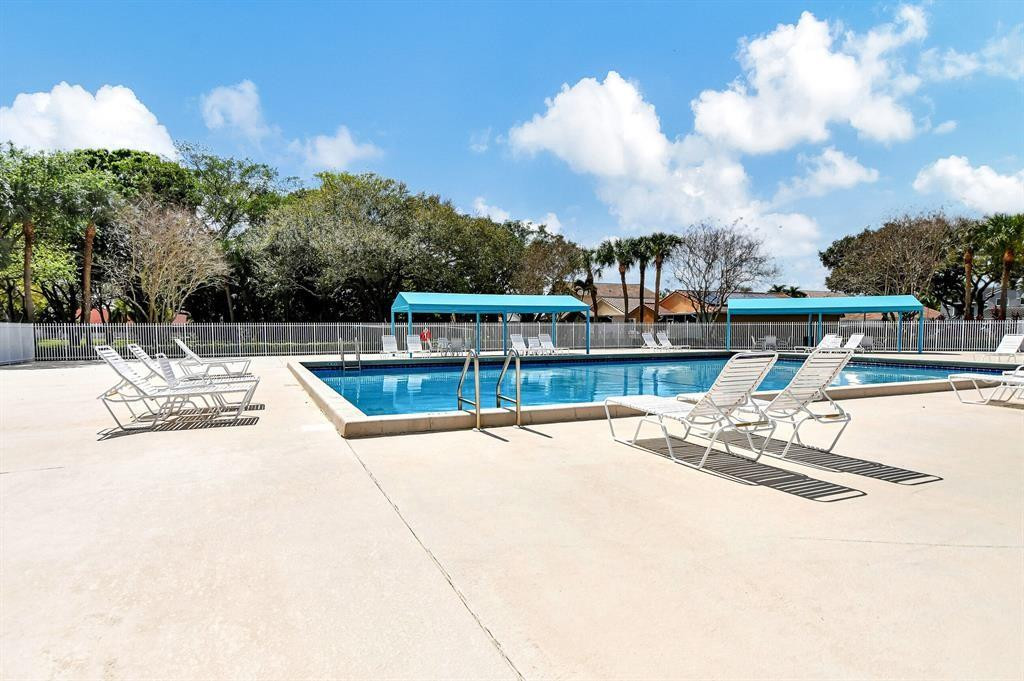 10423 Boca Springs Drive Boca Raton, FL 33428 - Photo 58 of 64 a view of a swimming pool with a lounge chair