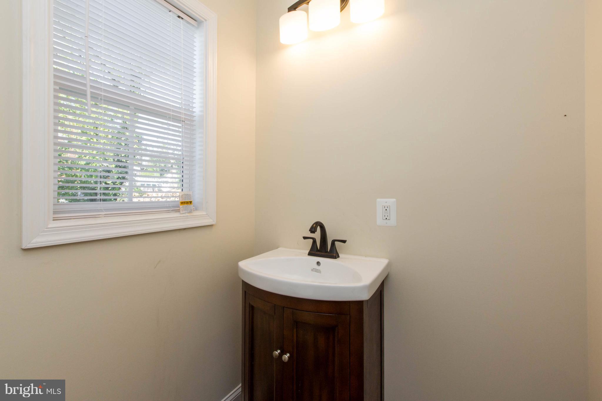 2016 Sulphur Spring Road Halethorpe, MD 21227 - Photo 14 of 30 a bathroom with a sink and a mirror