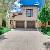 a front view of a house with a yard and a garage