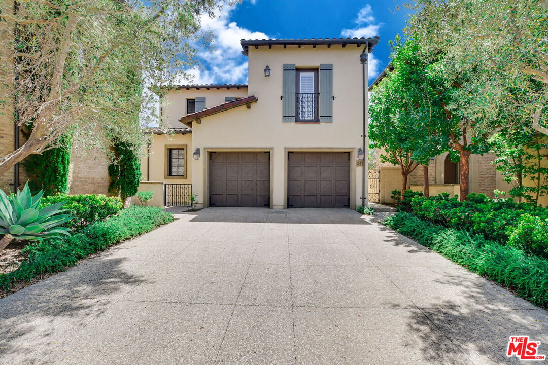 a front view of a house with a yard and a garage