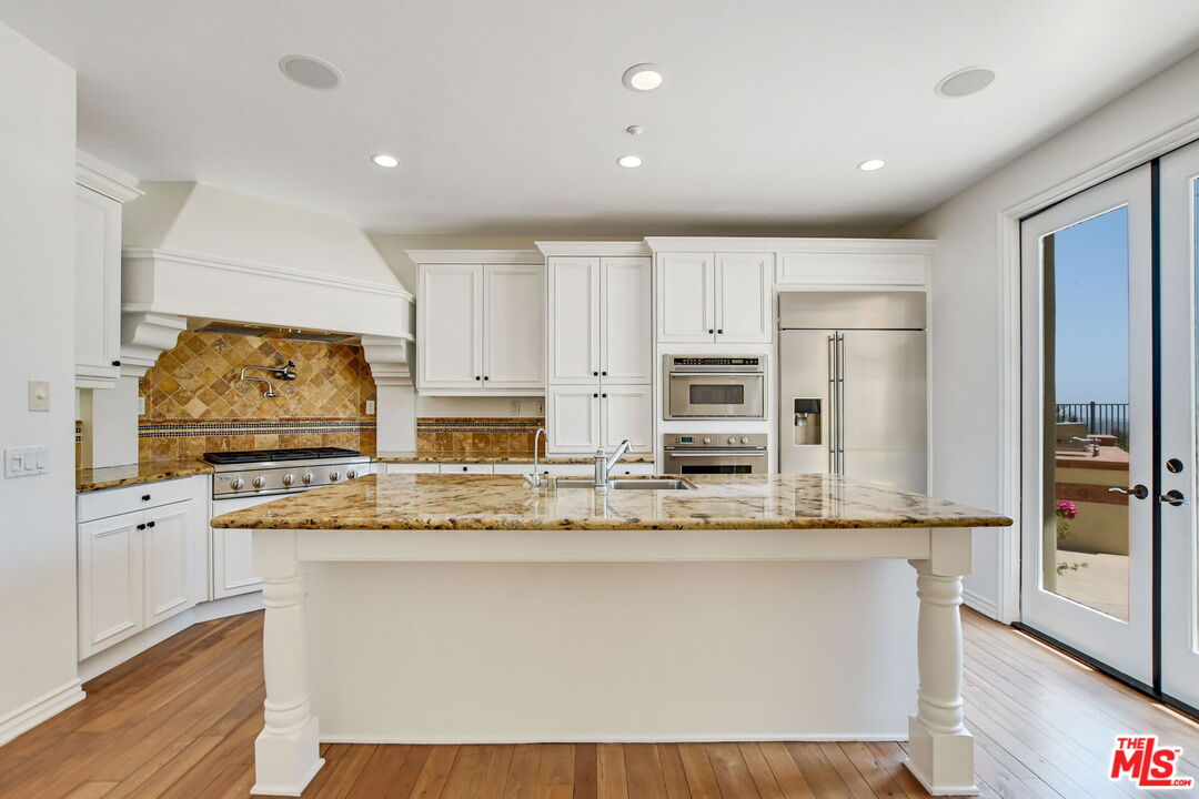24 Still Water Newport Coast, CA 92657 - Photo 14 of 56 a view of kitchen with stainless steel appliances granite countertop cabinets and wooden floor
