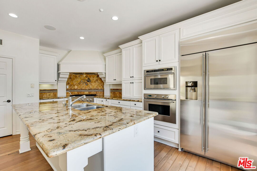 24 Still Water Newport Coast, CA 92657 - Photo 17 of 56 a kitchen with stainless steel appliances a stove a sink and a refrigerator