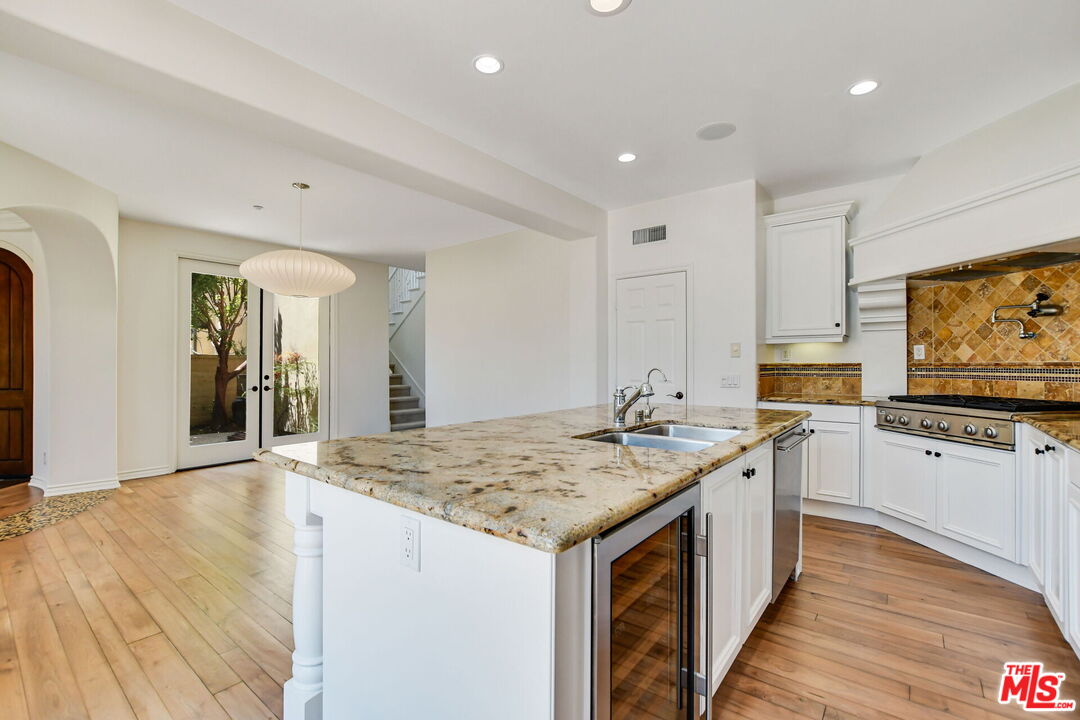 24 Still Water Newport Coast, CA 92657 - Photo 19 of 56 a open kitchen with stainless steel appliances granite countertop a sink and dishwasher with wooden floor