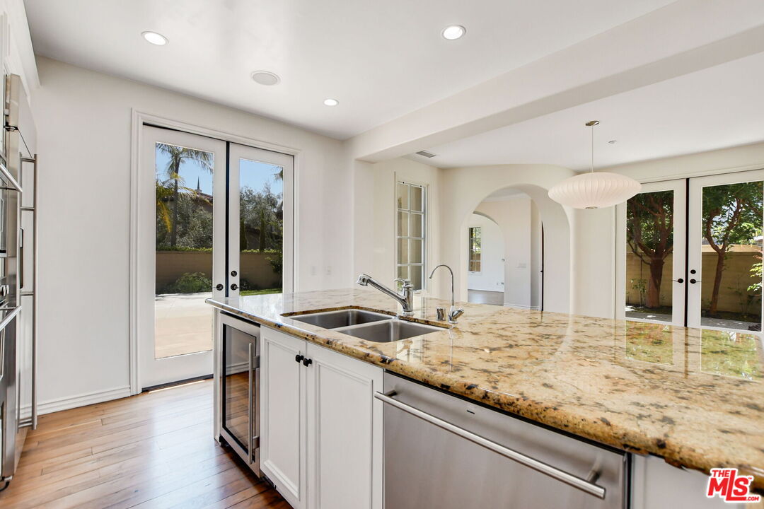 24 Still Water Newport Coast, CA 92657 - Photo 20 of 56 a kitchen with granite countertop sink and refrigerator