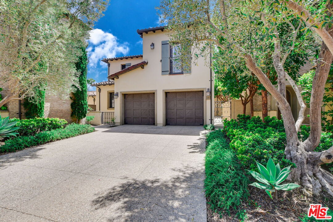 24 Still Water Newport Coast, CA 92657 - Photo 2 of 56 a view of a white house next to a yard with potted plants