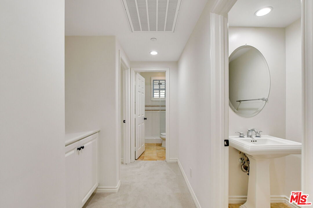 24 Still Water Newport Coast, CA 92657 - Photo 22 of 56 a bathroom with a sink and a mirror