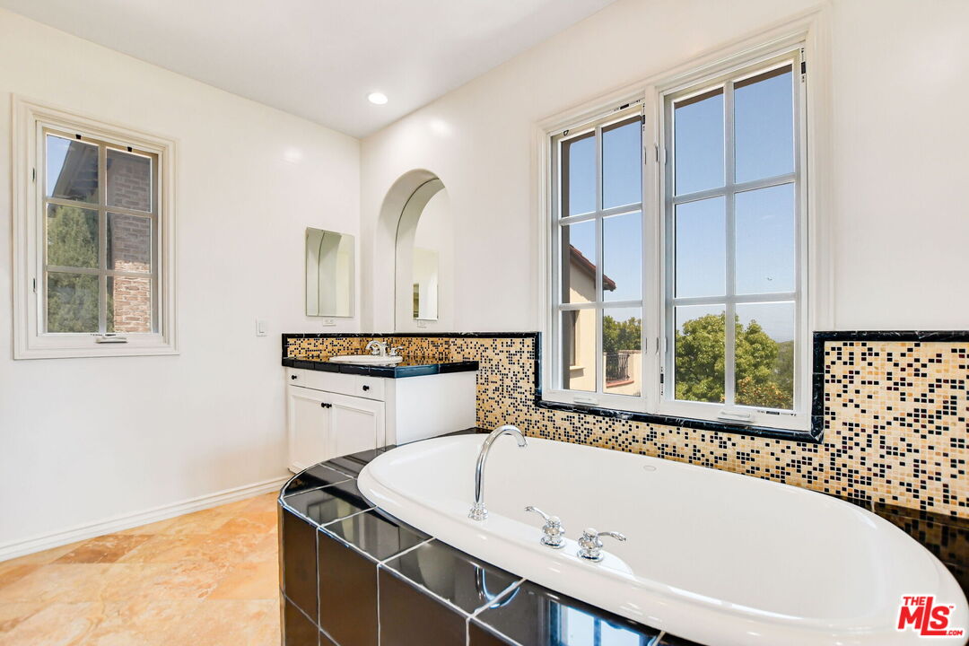 24 Still Water Newport Coast, CA 92657 - Photo 36 of 56 a bathroom with a bathtub and a window