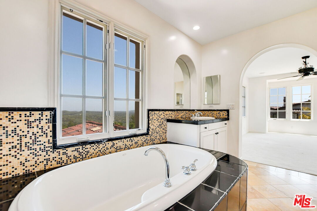 24 Still Water Newport Coast, CA 92657 - Photo 37 of 56 a bathroom with a bathtub and a sink