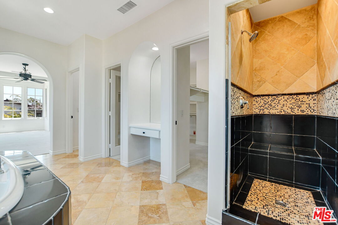 24 Still Water Newport Coast, CA 92657 - Photo 38 of 56 a bathroom with a mirror and a glass door shower