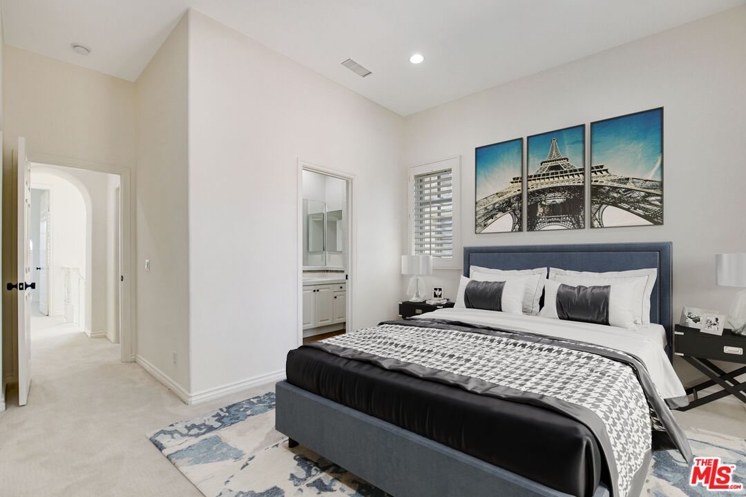 24 Still Water Newport Coast, CA 92657 - Photo 42 of 56 a bedroom with a large bed and a chandelier