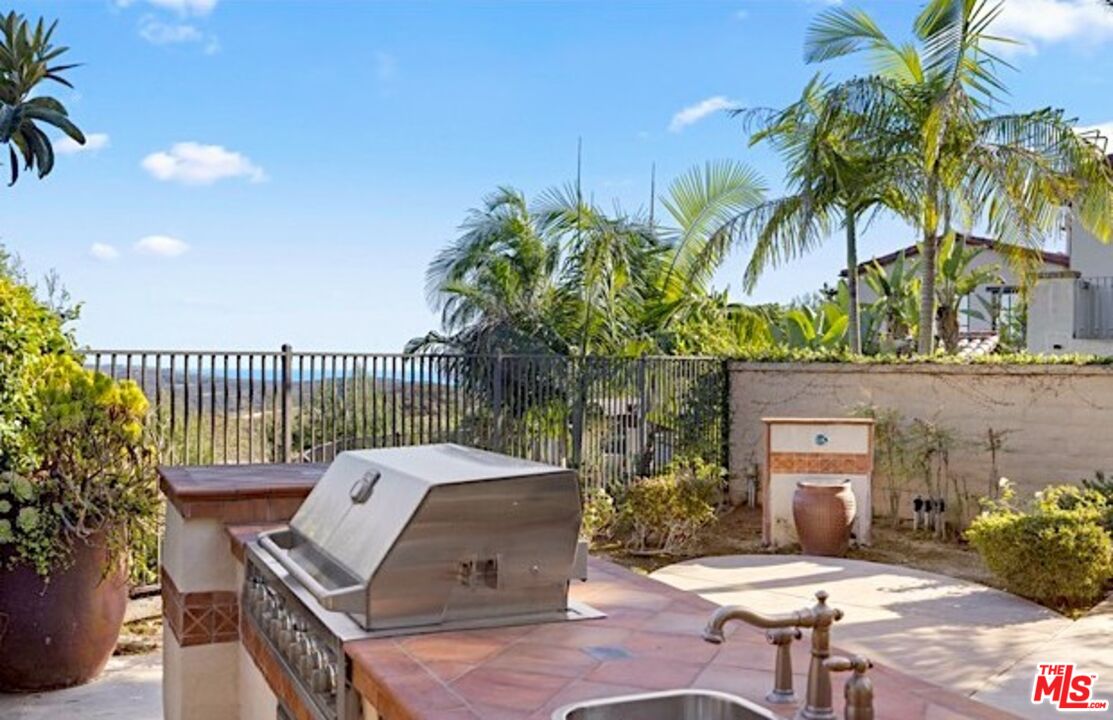 24 Still Water Newport Coast, CA 92657 - Photo 45 of 56 a view of a patio with couches table and chairs and potted plants