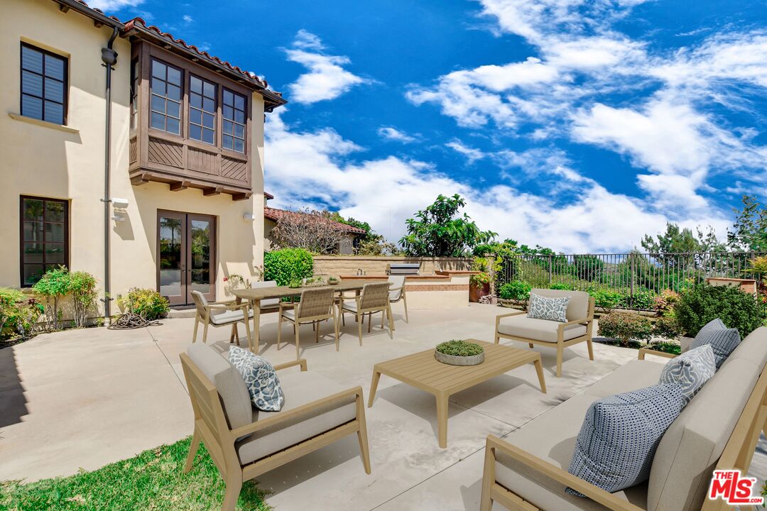 24 Still Water Newport Coast, CA 92657 - Photo 46 of 56 a view of a patio with couches and a table and chairs with garden view