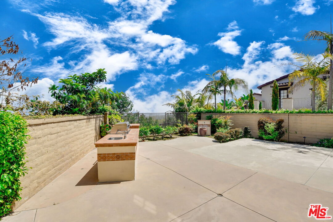 24 Still Water Newport Coast, CA 92657 - Photo 49 of 56 a backyard of a house with table and chairs