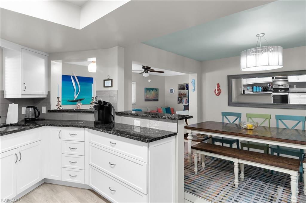 1337 Wisconsin Drive Naples, FL 34103 - Photo 11 of 35 a kitchen with granite countertop a sink and cabinets