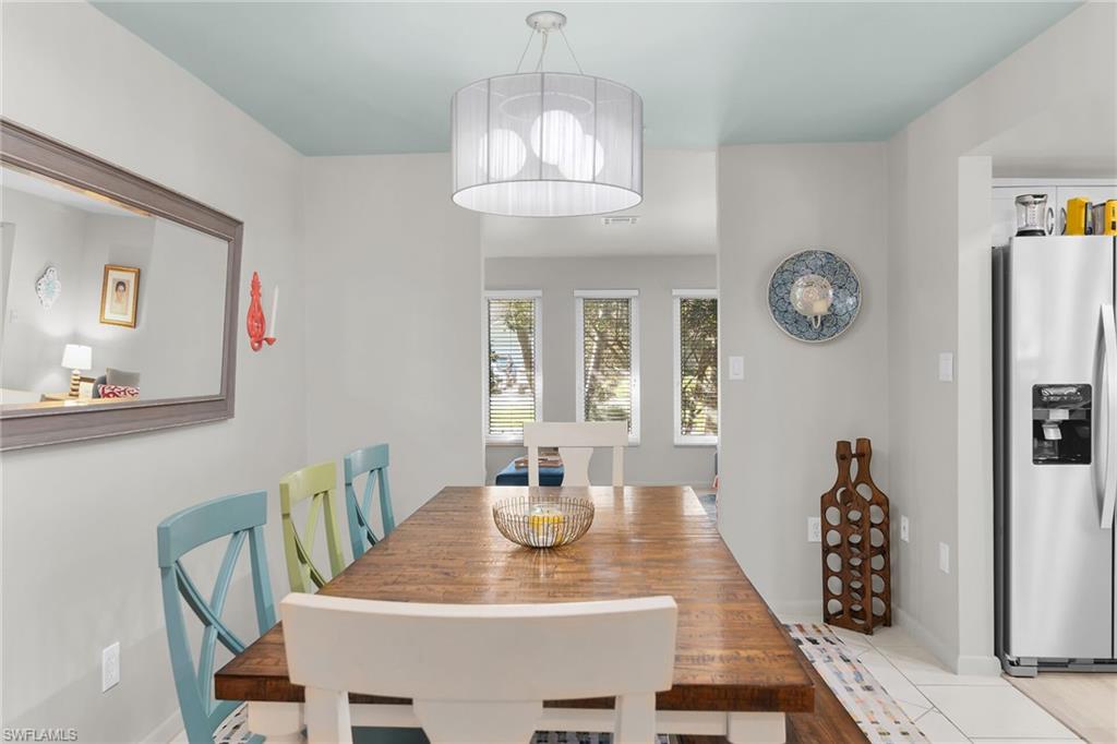 1337 Wisconsin Drive Naples, FL 34103 - Photo 13 of 35 a view of a dining room with furniture wooden floor and a chandelier