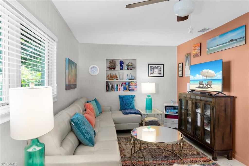 1337 Wisconsin Drive Naples, FL 34103 - Photo 15 of 35 a living room with furniture and a flat screen tv
