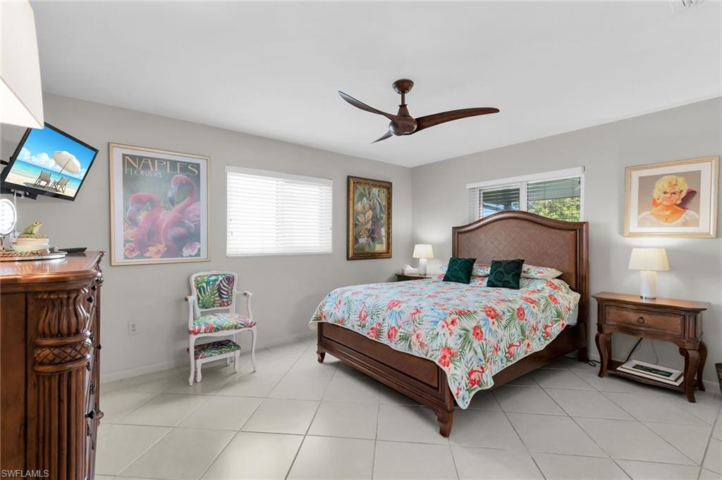 1337 Wisconsin Drive Naples, FL 34103 - Photo 17 of 35 a bedroom with a bed painting on wall and a window