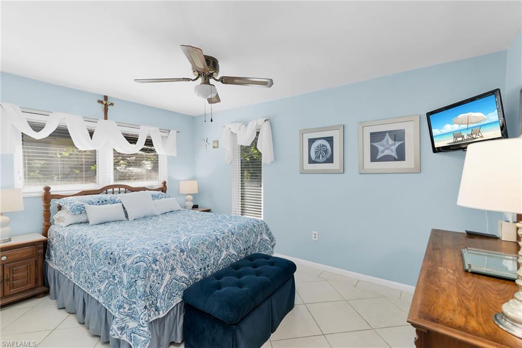 1337 Wisconsin Drive Naples, FL 34103 - Photo 21 of 35 a living room with a couch and a lamp