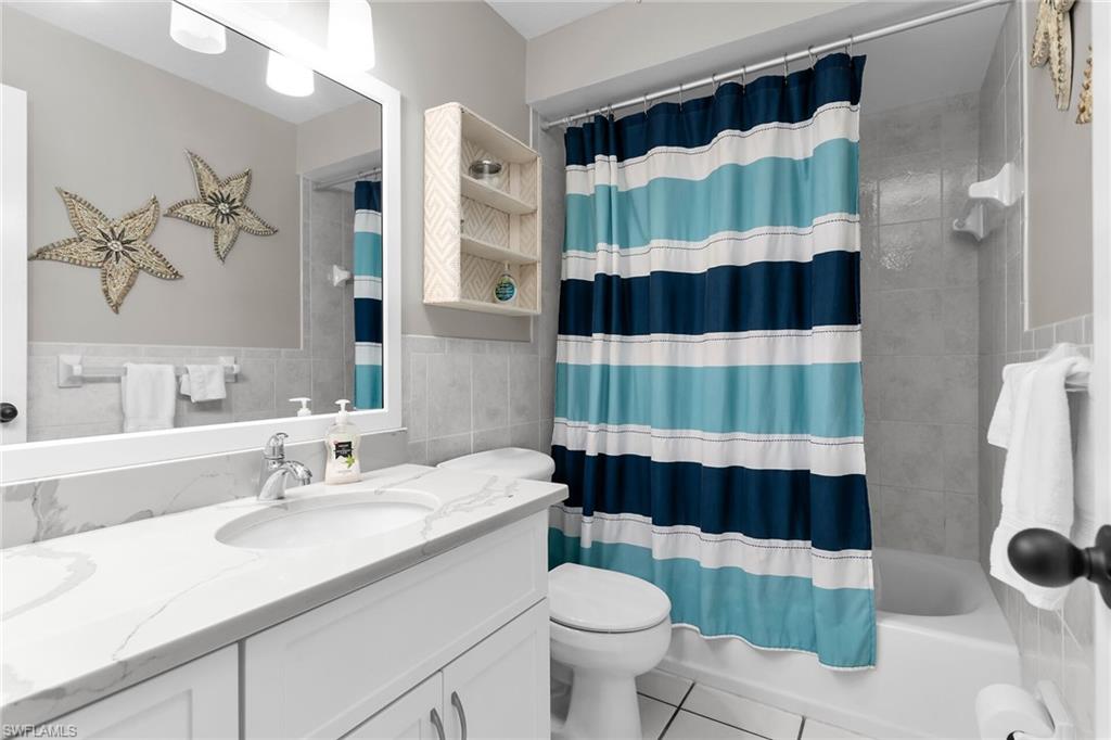 1337 Wisconsin Drive Naples, FL 34103 - Photo 22 of 35 a bathroom with a sink and a toilet