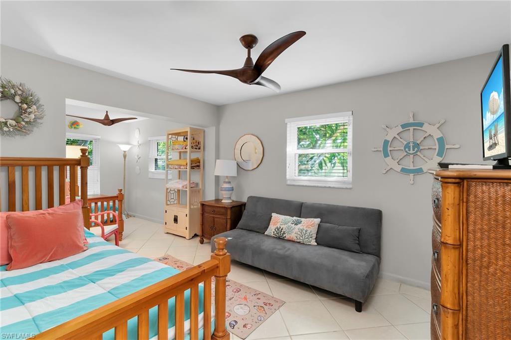 1337 Wisconsin Drive Naples, FL 34103 - Photo 23 of 35 a living room with furniture a window and a clock