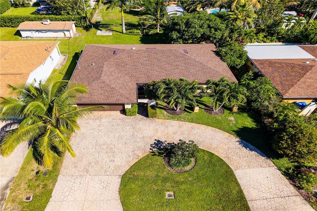 1337 Wisconsin Drive Naples, FL 34103 - Photo 30 of 35 an aerial view of a house with a yard and a large pool