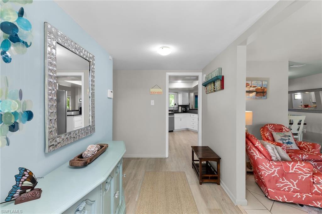 1337 Wisconsin Drive Naples, FL 34103 - Photo 5 of 35 a bedroom with furniture and a wooden floor