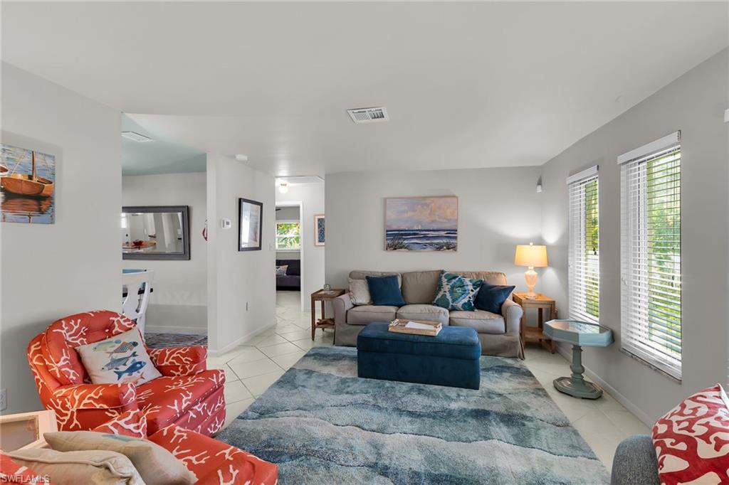 1337 Wisconsin Drive Naples, FL 34103 - Photo 6 of 35 a living room with furniture and a large window