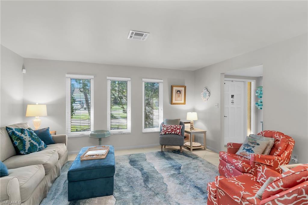 1337 Wisconsin Drive Naples, FL 34103 - Photo 7 of 35 a living room with furniture and a large window