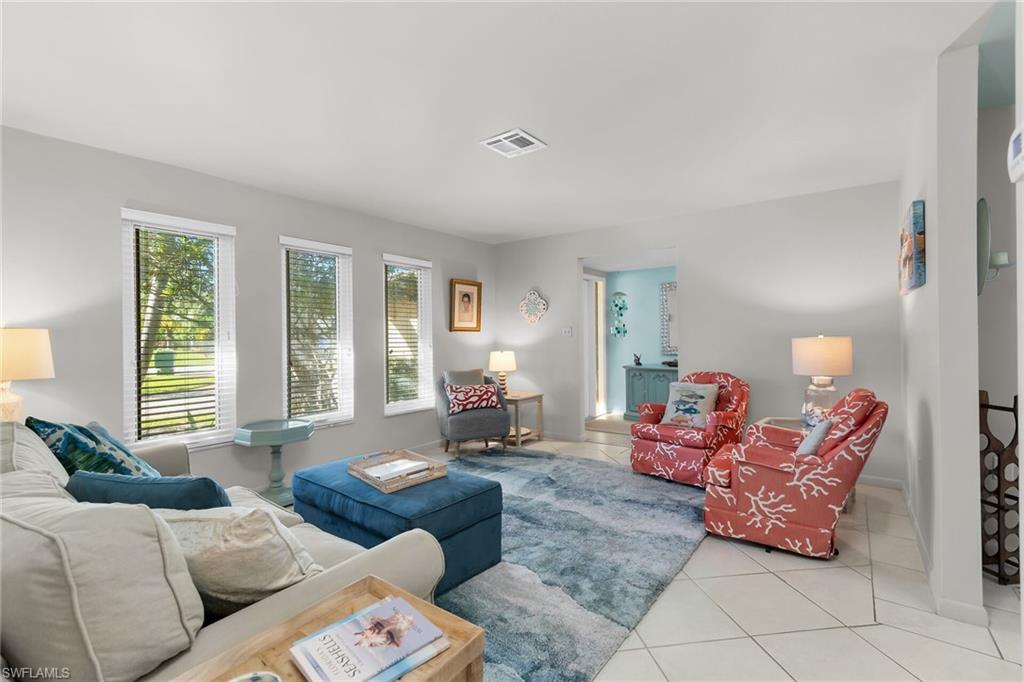 1337 Wisconsin Drive Naples, FL 34103 - Photo 8 of 35 a living room with furniture and a large window
