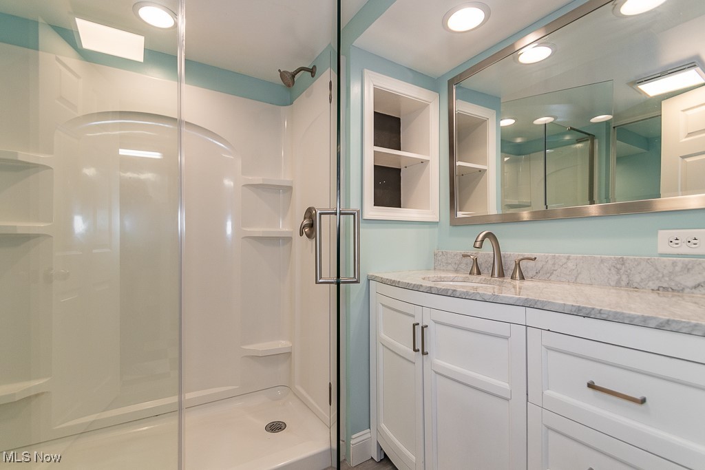 38856 Johnnycake Ridge Road Willoughby, OH 44094 - Photo 20 of 49 Lower level bathroom with an enclosed shower and vanity