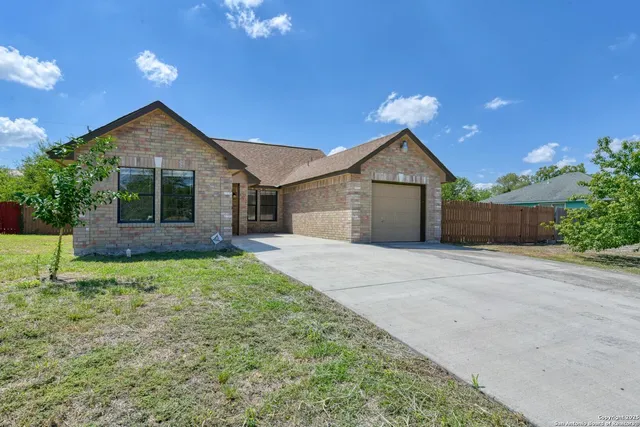 front view of a house with yard and a garage